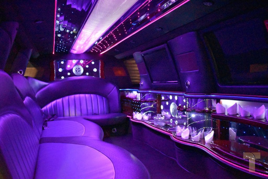 Stretch SUV Limousine interior with lit bar and side seating
