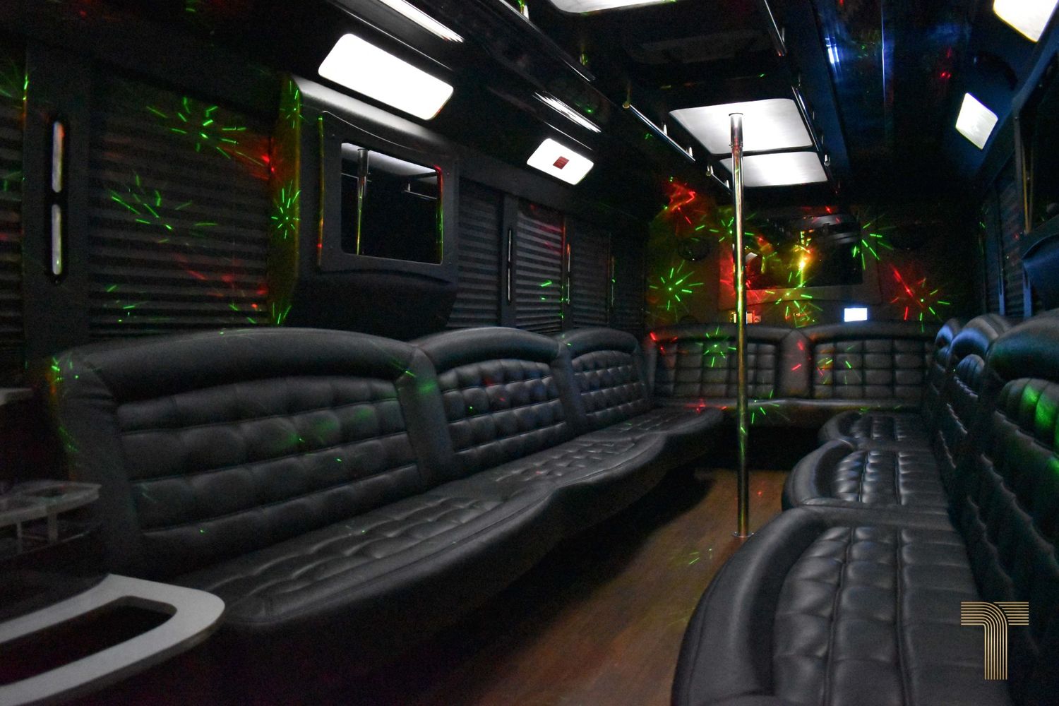 Party bus interior with lounge seating and ambient lighting